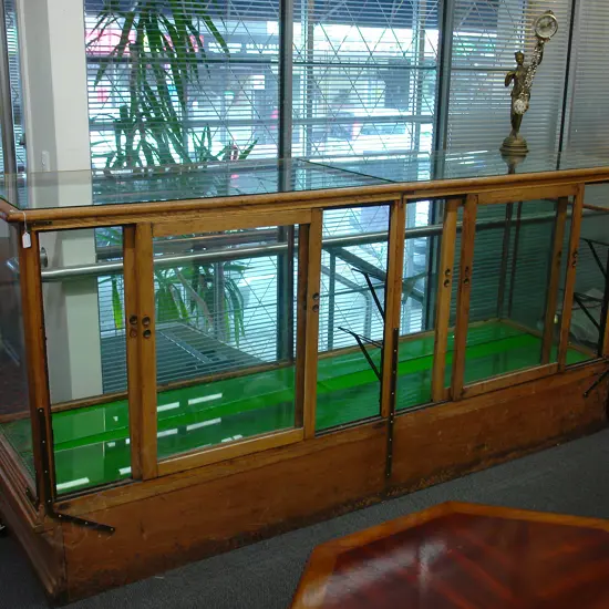 A vintage mahogany shop display cabinet