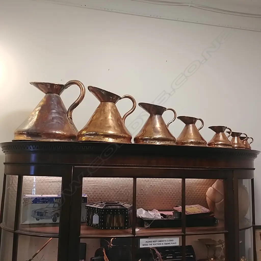 7 GRADUATED COPPER MEASURING JUGS Image 1++