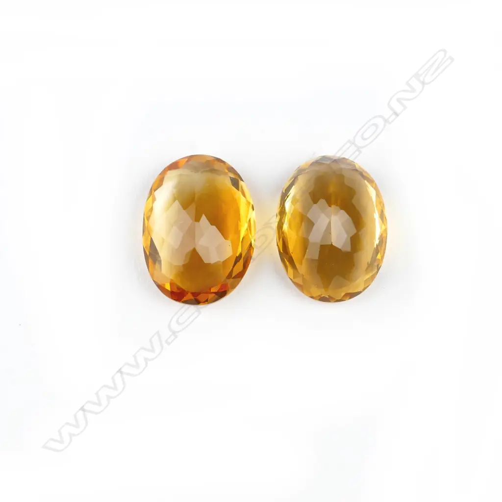 A pair of oval facet cut citrine gemstones Image 1++