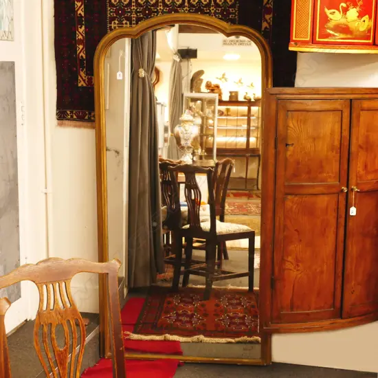 A large full length gilt framed mirror