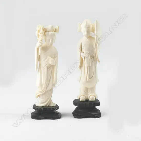 A pair of Chinese carved ivory figures of a woman and man