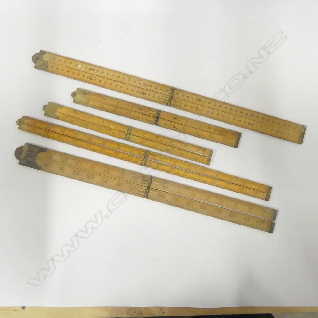 Five Folding boxwood rulers by J Rabone & Sons: No. 1112 brass edged 24": No. 1118 24" (chip to edge); No. 1168 24"; No. 1380 36" and No.1181 1m Rabone Chesterman. (5) Image 1++