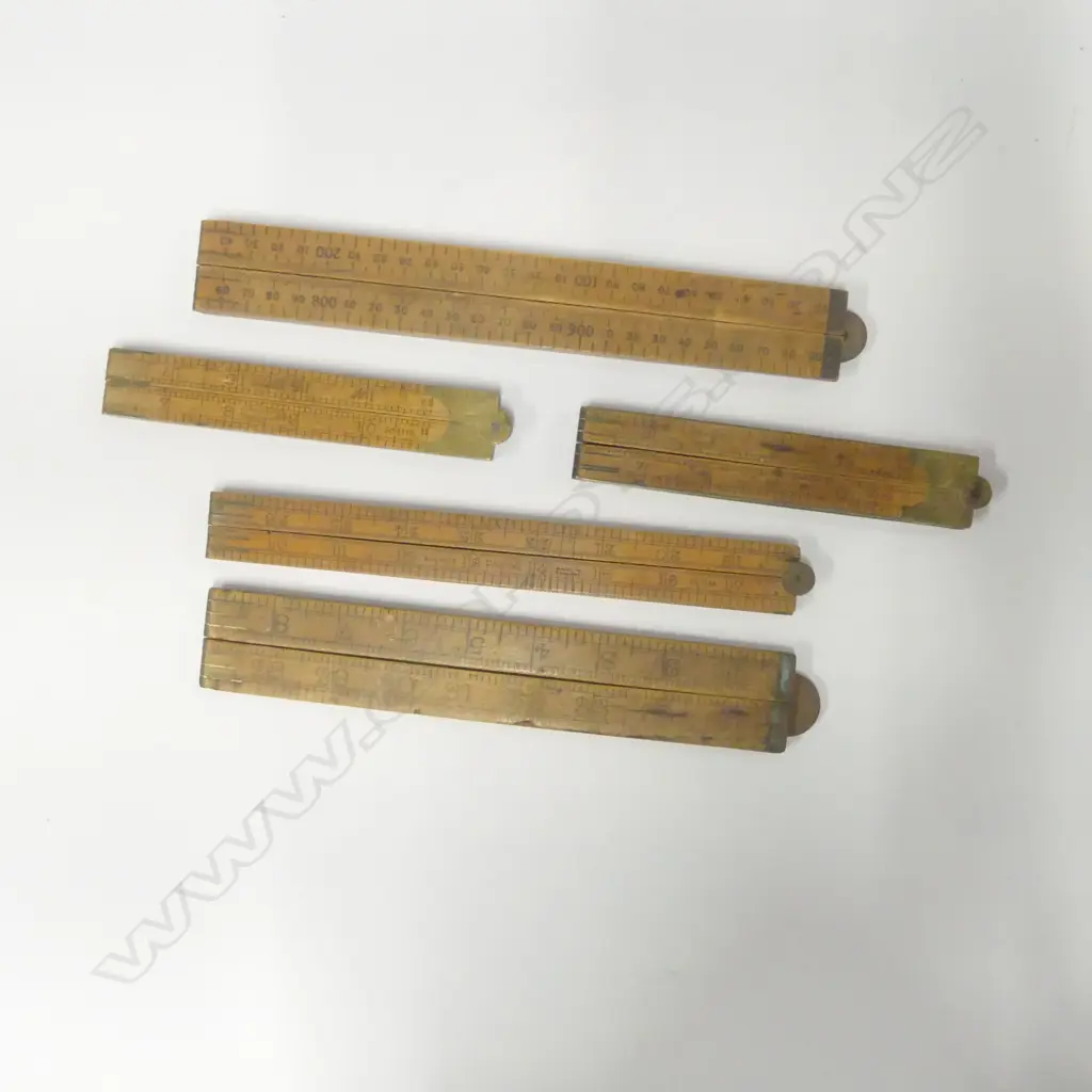 Five Folding boxwood rulers by J Rabone & Sons: No. 1112 brass edged 24": No. 1118 24" (chip to edge); No. 1168 24"; No. 1380 36" and No.1181 1m Rabone Chesterman. (5) Image 1++