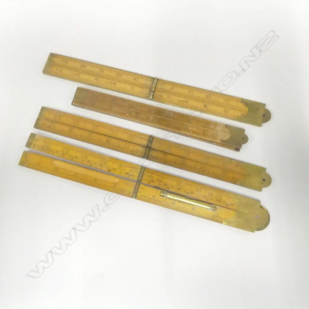 Four folding rules, one Rabone #1113 brass edged, one Rabone #1190 with level, and two others. Image 1++
