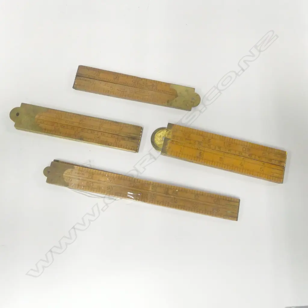 Four folding rules, one Rabone #1113 brass edged, one Rabone #1190 with level, and two others. Image 1++