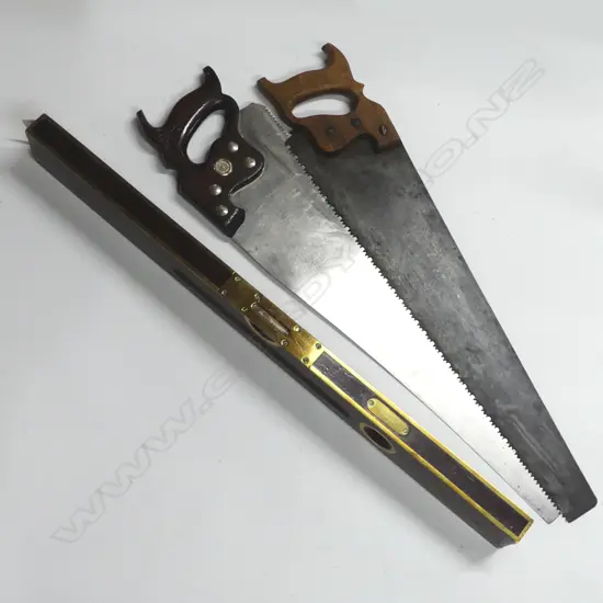 Two various panel saws and a Stanley Rule & Level Co brass and mahogany level, (Patented 1898 and earlier), in green canvas bag