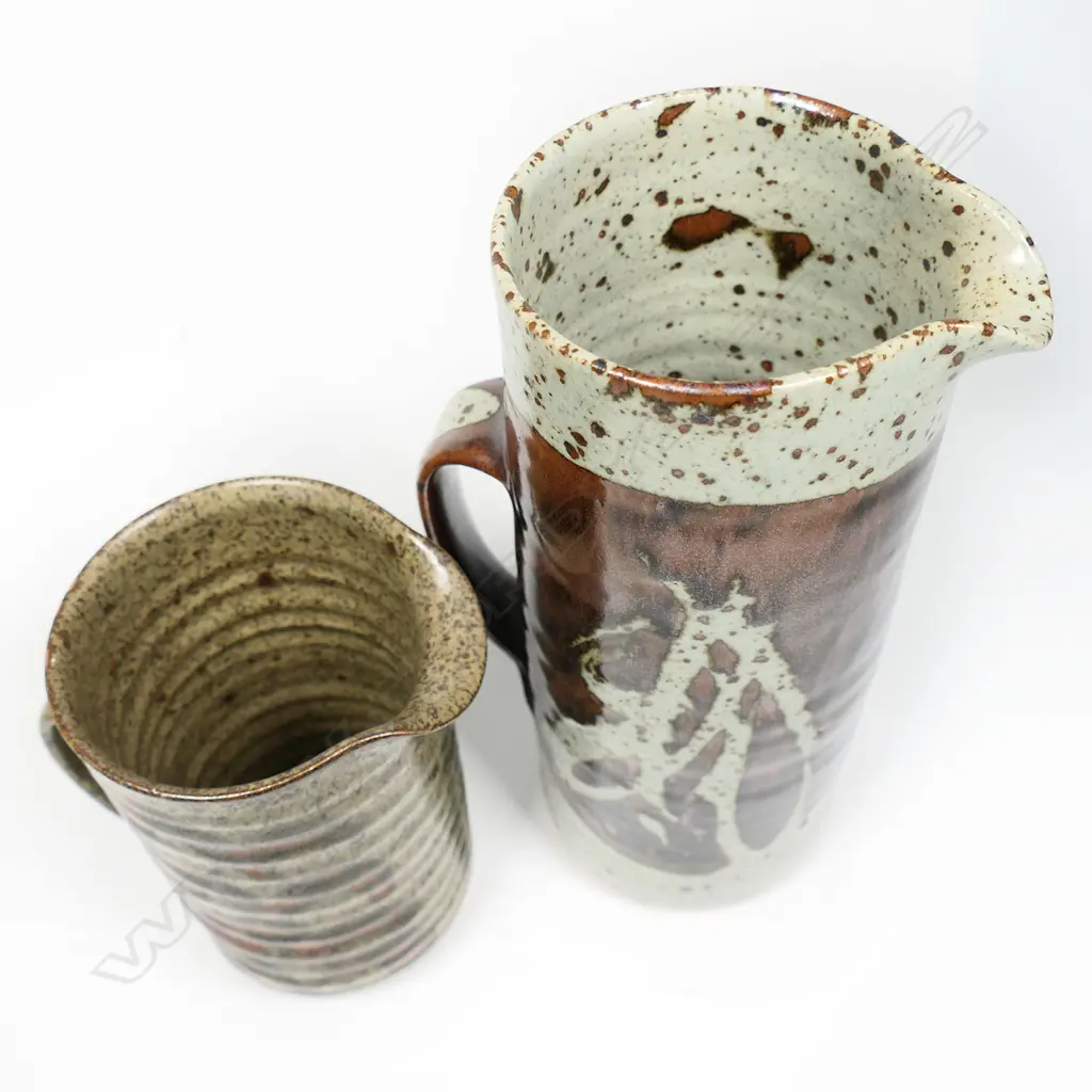 Two Adrian Cotter Jugs; salt glaze with bold wax-resist & brushed feather design. Tall - potter's mark to base H.255 Image 1++