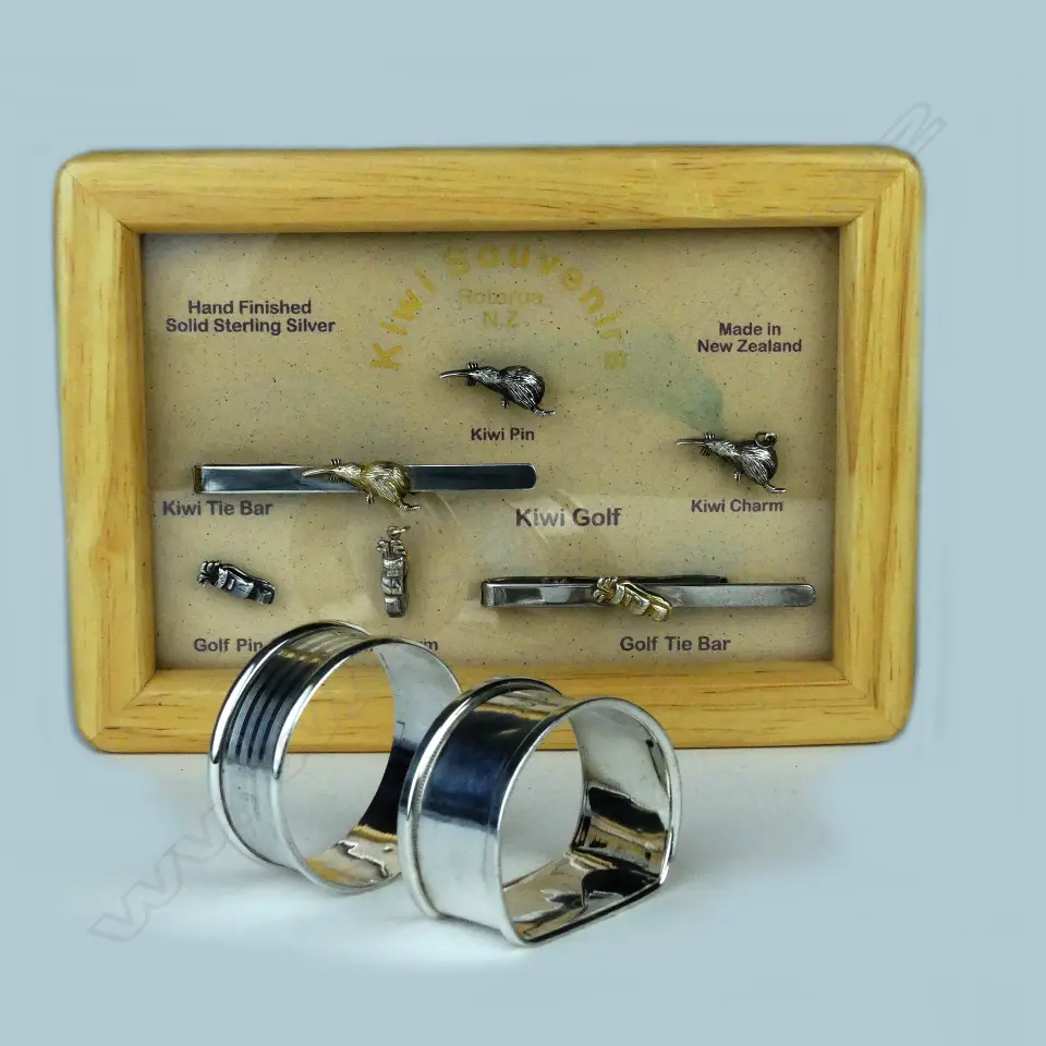 Five golfing sterling silver pins mounted in a wooden frame Image 1++