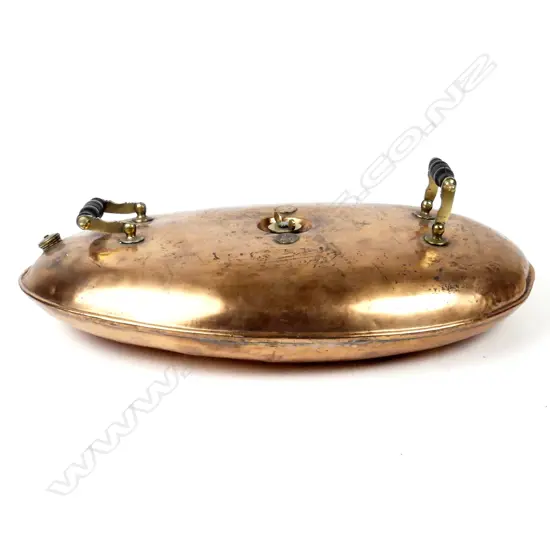 A copper bed warmer