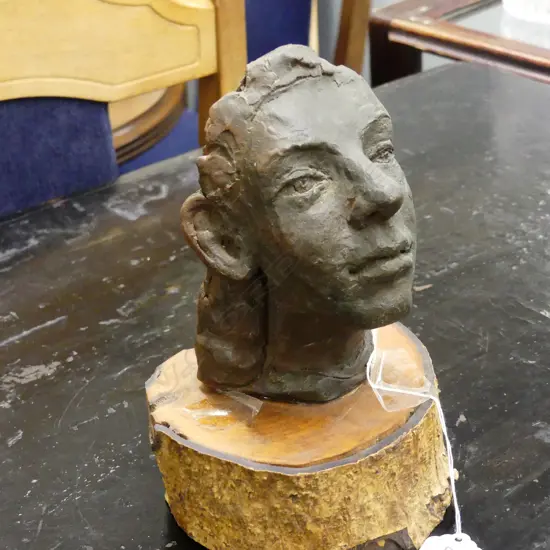 SMALL CERAMIC MODEL OF A WOMAN'S HEAD ON WOODEN BASE