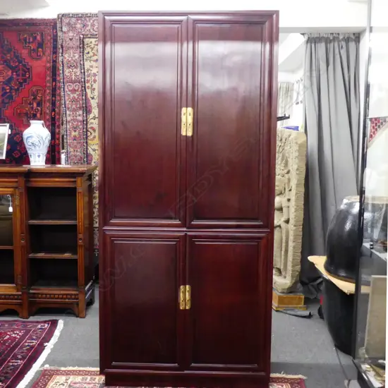 A Chinese rosewood four door cabinet