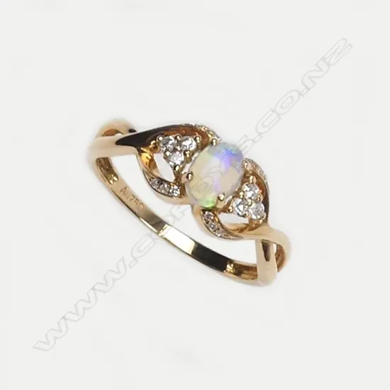 A modern 18ct. rose gold opal and diamond dress ring