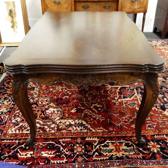 A reproduction French oak marquetry extension dining table