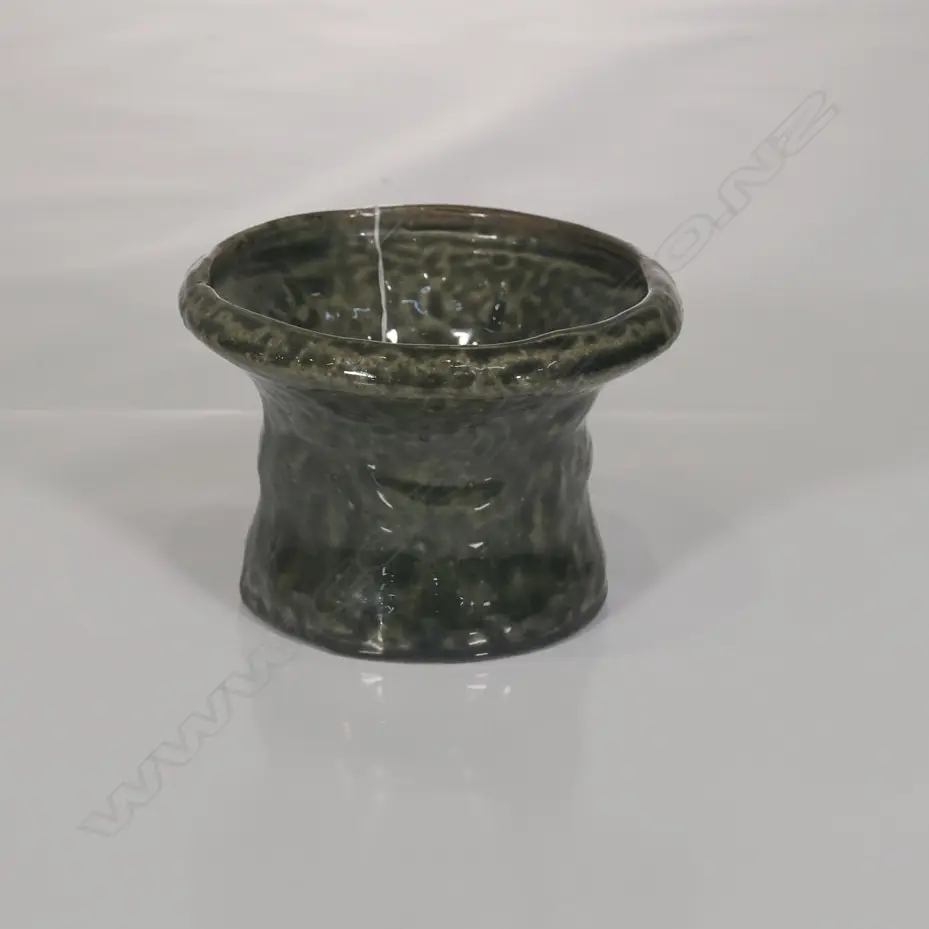 Circular section with wide flared rim and a rich green glaze Image 1++