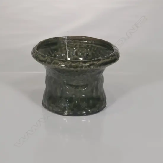 Circular section with wide flared rim and a rich green glaze