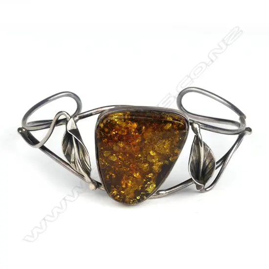 An Arts & Crafts amber and silver cuff bangle