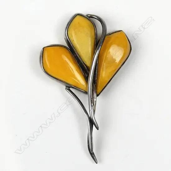 A stylish amber and silver brooch