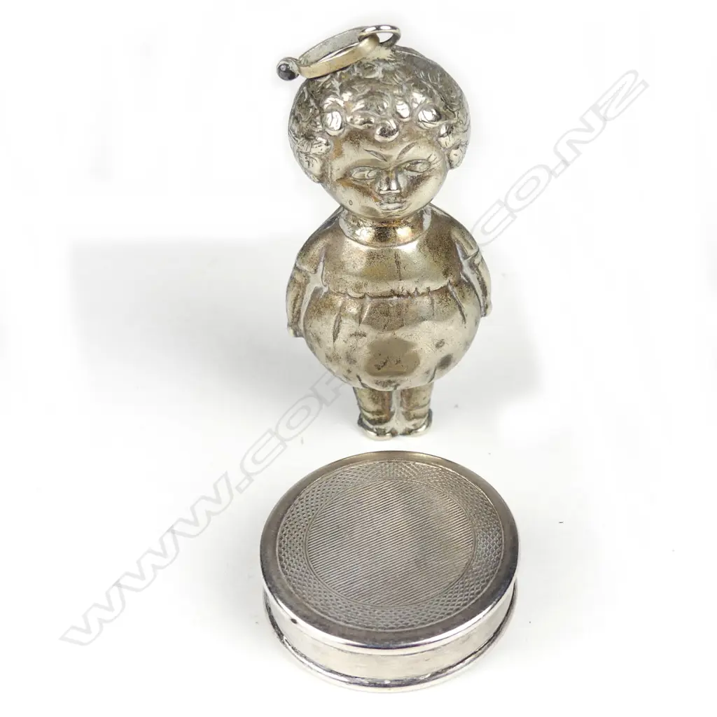 A sterling silver pill box and a 1920s silver plated baby's rattle Image 1++