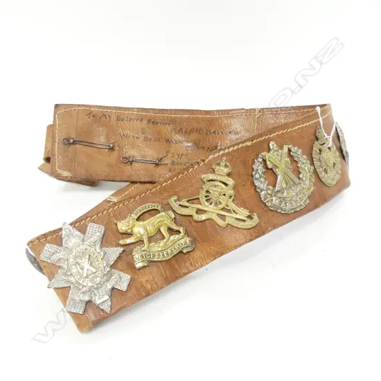 (18358) OLD MILITARY BELT WITH MULTIPLE BADGES