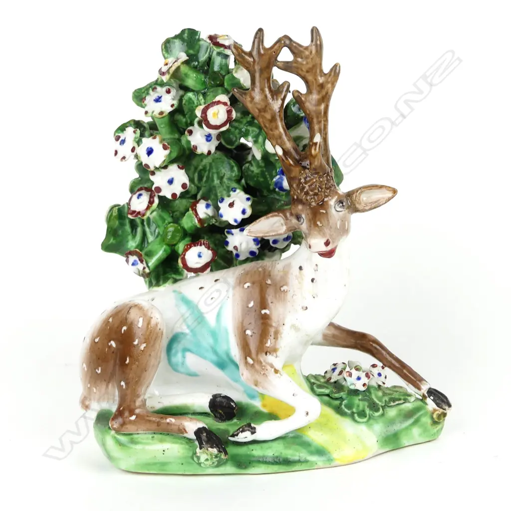 A 19thC porcelain Staffordshire type recumbent deer figure Image 1++
