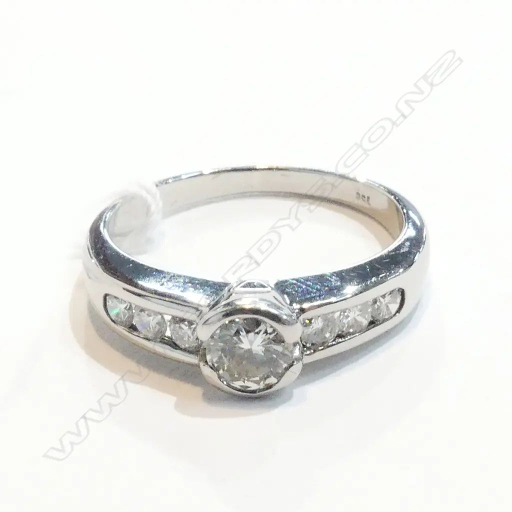 0.30ct round brilliant cut diamond rubover set with a further three diamonds set to each shoulder Image 1++