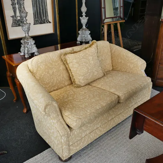 YELLOW UPHOLSTERED SEATEE ON BUN FEET H 750MM W 1500MM