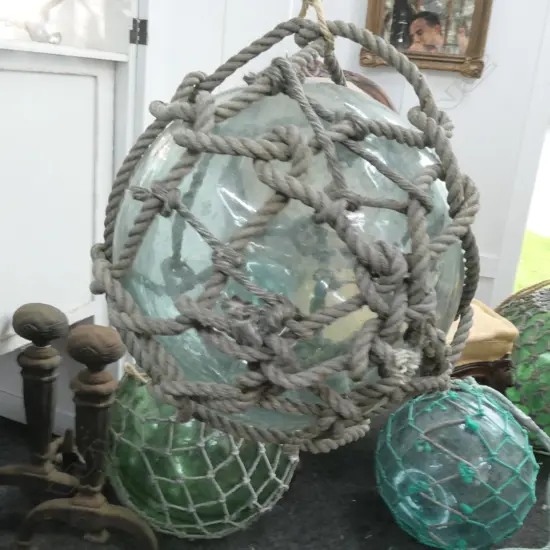 OLD LARGE GLASS FISHING FLOAT WITH NETTING...
