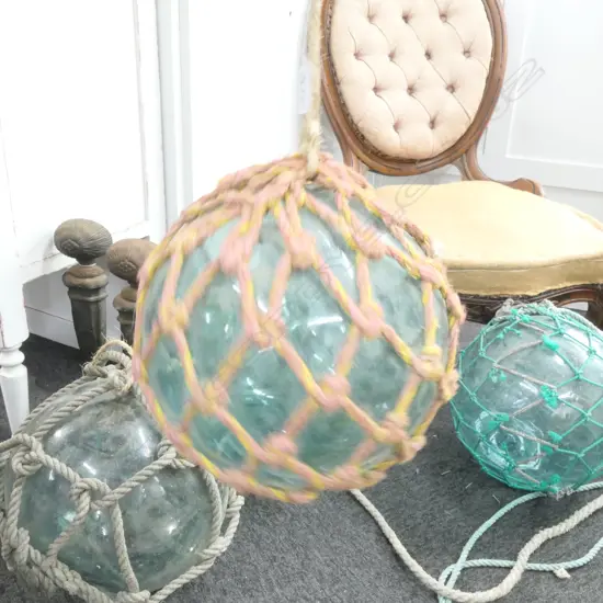 OLD GLASS FISHING FLOAT WITH NETTING...