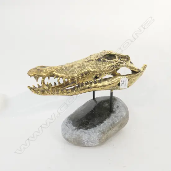 CAST POLISHED BRONZE OF A CROCODILE SKULL MONTED ON A PONAMU BASE L 370 MM