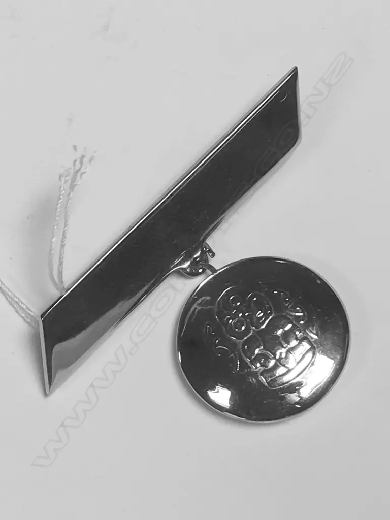 BROOCH WITH DOUBLED SIDED DROP SHOWING MAORI TIKI AND ON REVERSE A SAILING SHIP Image 1++