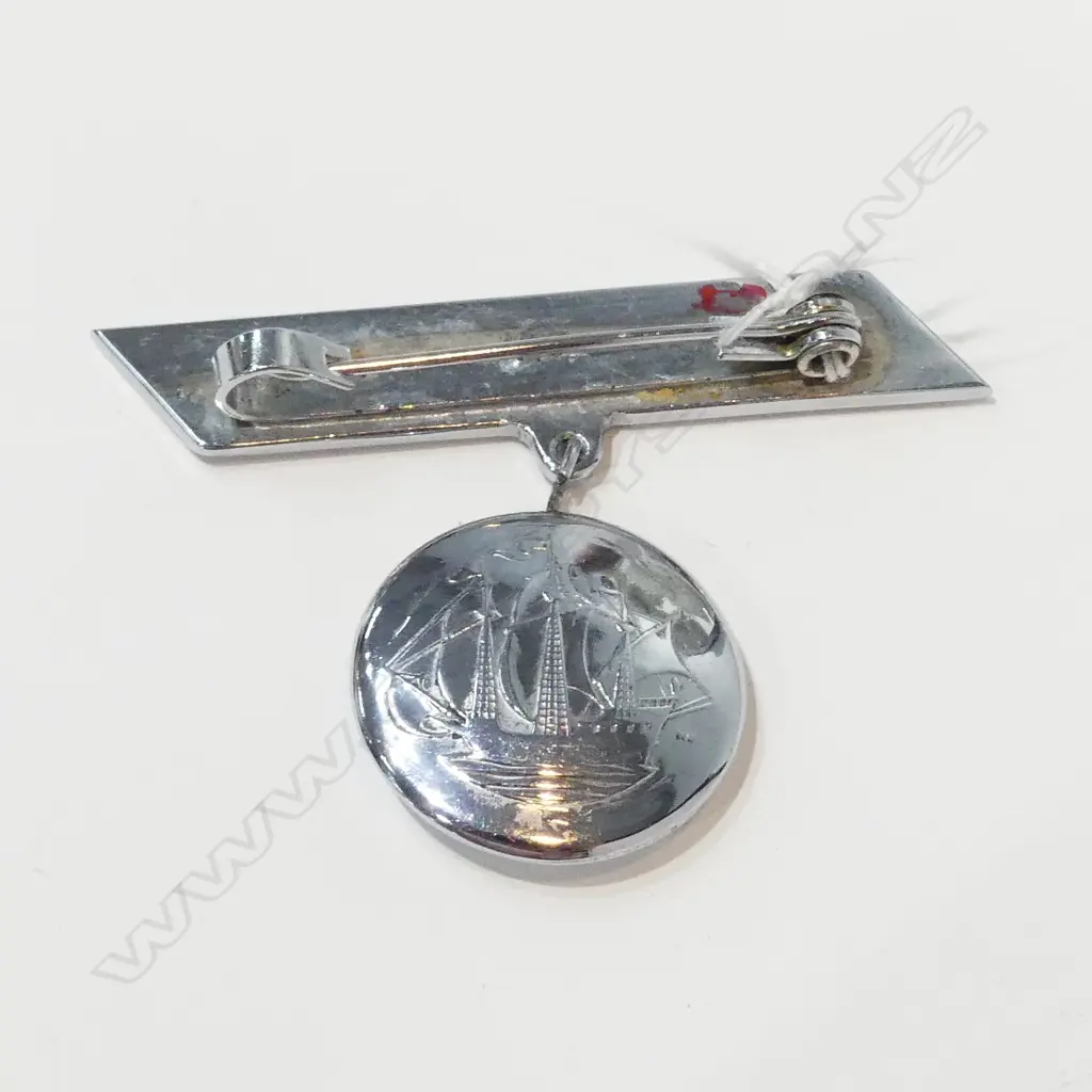 BROOCH WITH DOUBLED SIDED DROP SHOWING MAORI TIKI AND ON REVERSE A SAILING SHIP Image 1++