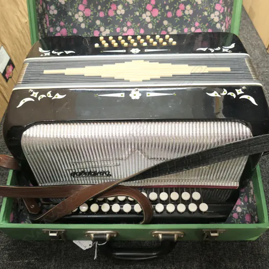 ACCORDION IN GREEN CASE