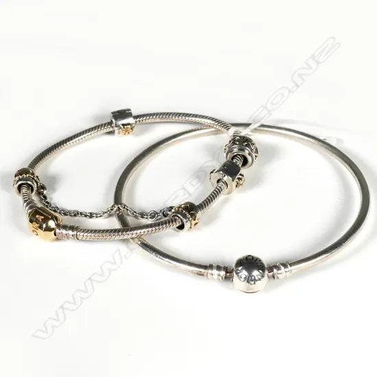 TWO PANDORA SILVER BRACELETS ONE WITH GOLD CLASP & SILVER/GOLD CHARMS