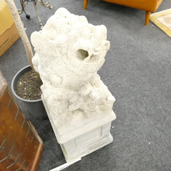 PAIR OF CARVED STONE LIONS ON PLINTHS
