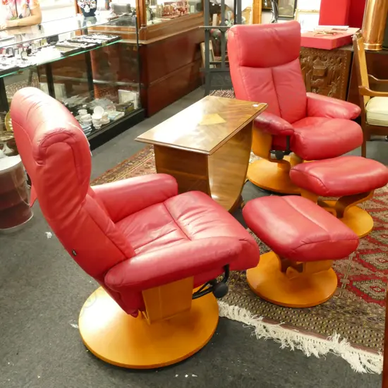 PAIR OF RED LEATHER UPHOLSTERED RECLINING ARM CHAIRS WITH STOOLS