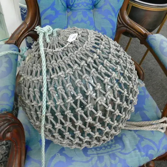OLD LARGE GLASS FISHING FLOAT WITH NETTING...