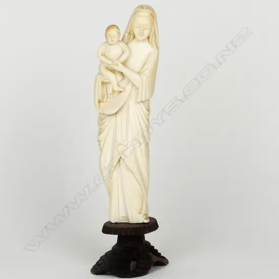 An old carved ivory standing figure of the Madonna and Child