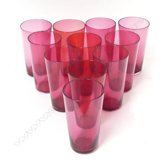 Twelve cranberry glass small beakers