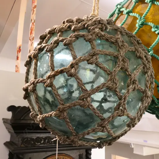 2 OLD GLASS FISHING FLOATS WITH NETTING...