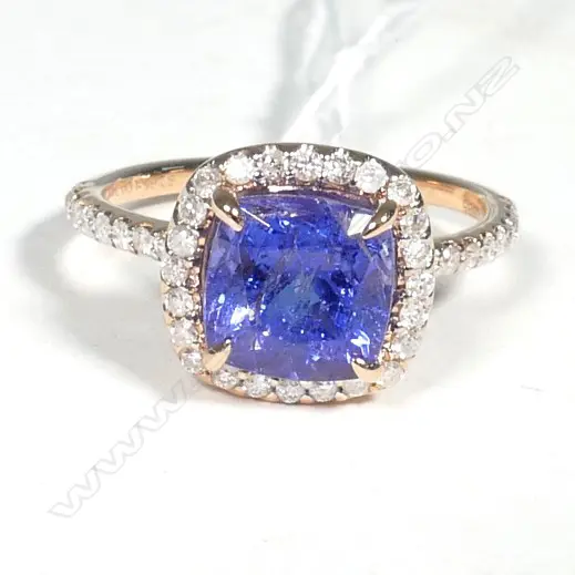 14ct Rose Gold Tanzanite and Diamond halo ring featuring centre Image 1++