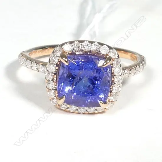 14ct Rose Gold Tanzanite and Diamond halo ring featuring centre