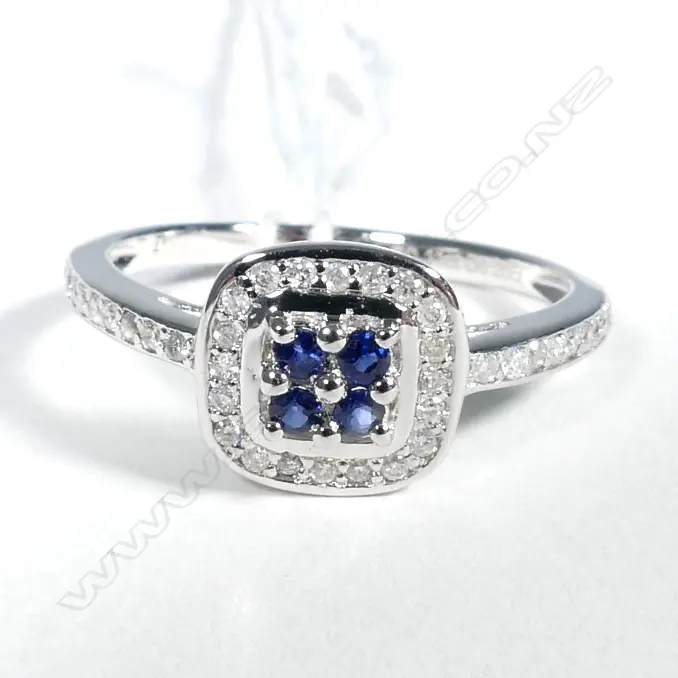 10ct White Gold Sapphire and Diamond halo ring featuring centre Image 1++