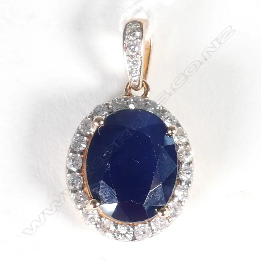 14ct Rose Gold Sapphire and Diamond halo pendant featuring centre Image 1++