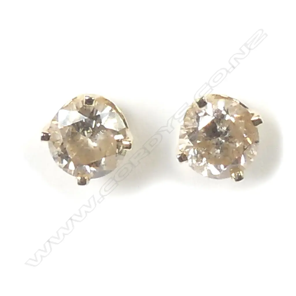 A pair of 14ct gold and diamond stud earrings Image 1++