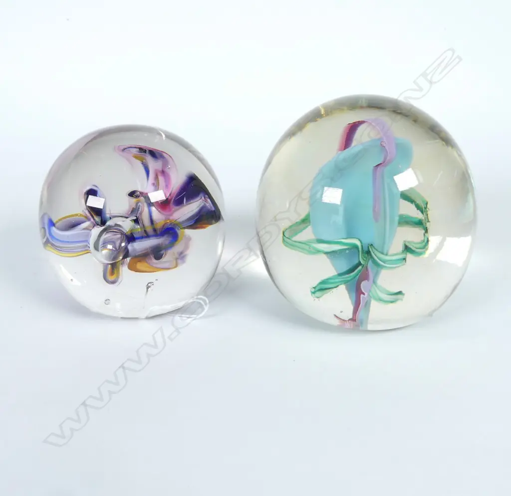 NZ GLASS PAPERWEIGHT, CLEAR WITH COLOURED RIBBONS & GLASS PAPERWEIGHT, WITH ORCHID FLOWERS, SIGNED	 Image 1++