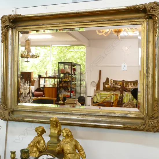 A GILT FRAMED BEVELLED GLASS MIRROR 820 X 550 MM
