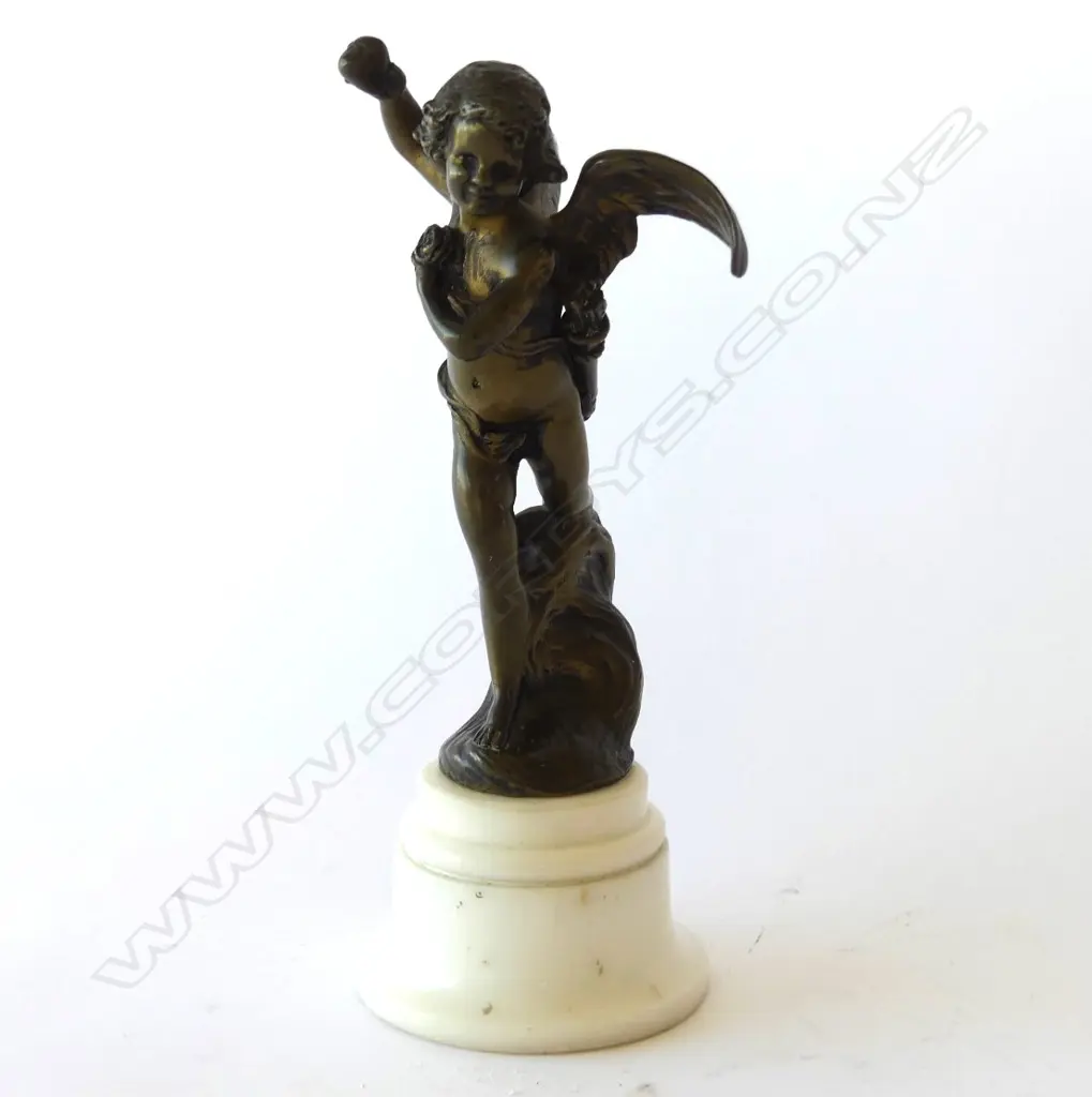 SMALL BRONZED CUPID ON A MARBLE STAND, SIGNED 'J DUNACH' TO BASE Image 1++