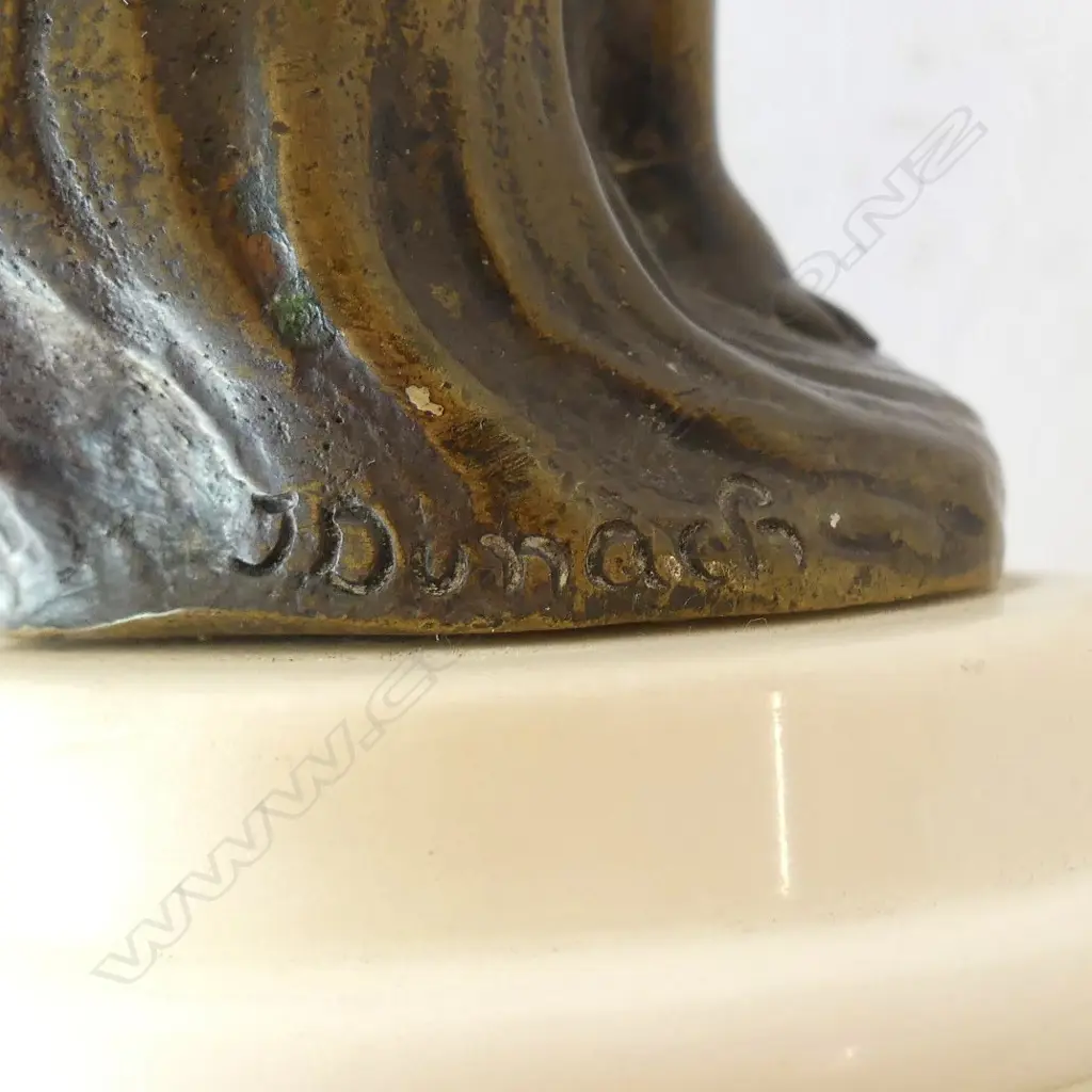 SMALL BRONZED CUPID ON A MARBLE STAND, SIGNED 'J DUNACH' TO BASE Image 1++