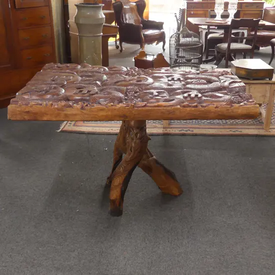 LGE MAORI CARVED CENTER TABLE TRIPOD BASE GLASS TOP...
