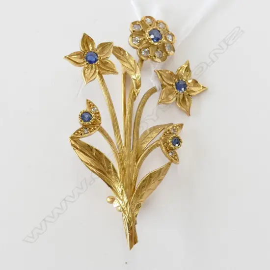 An 18ct yellow gold sapphire and diamond designer floral brooch